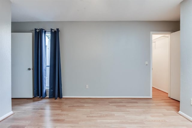 spare room featuring light wood-type flooring