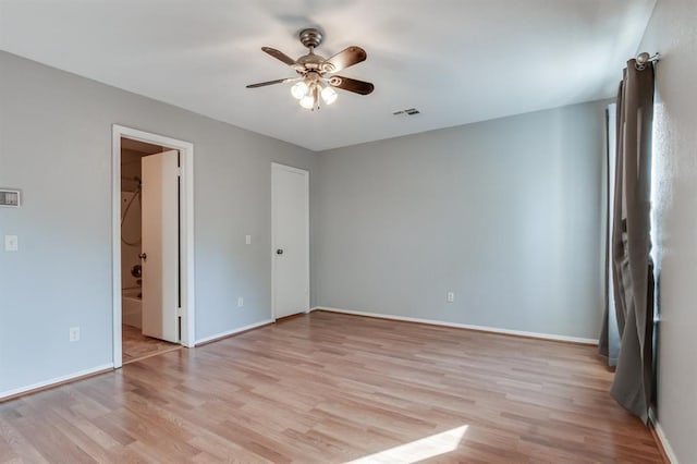 spare room with light hardwood / wood-style flooring and ceiling fan