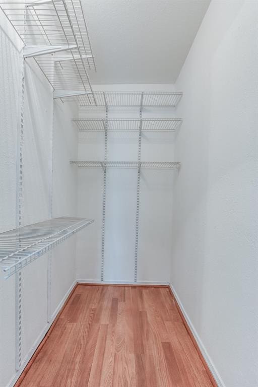 walk in closet featuring hardwood / wood-style floors