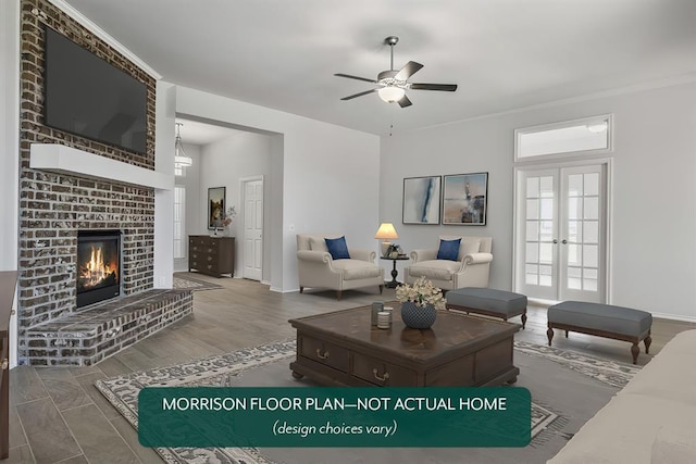 living room with ceiling fan, a fireplace, hardwood / wood-style floors, and a wealth of natural light