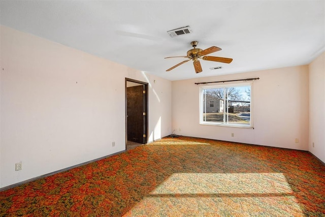 carpeted empty room featuring ceiling fan