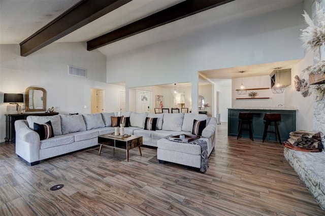 living room featuring high vaulted ceiling, beam ceiling, and hardwood / wood-style floors