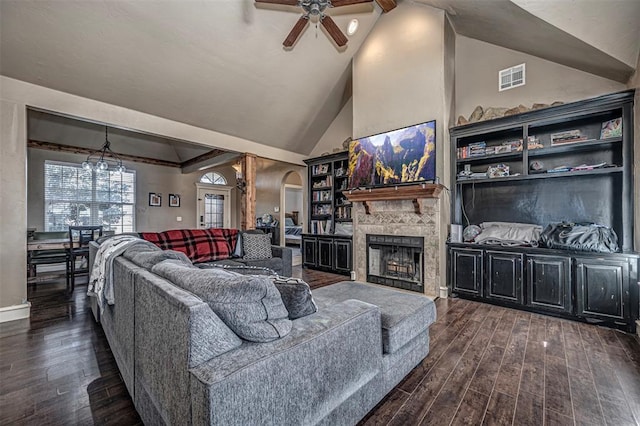 living room with ceiling fan with notable chandelier, a large fireplace, dark hardwood / wood-style flooring, and high vaulted ceiling