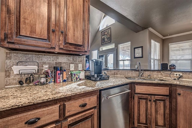 kitchen with tasteful backsplash, sink, crown molding, and light stone countertops