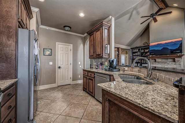 kitchen featuring sink, light tile patterned floors, stainless steel appliances, light stone countertops, and backsplash