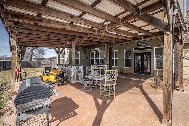 view of patio featuring fence and outdoor dining area