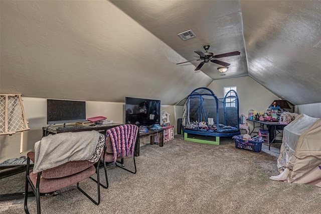 game room with carpet floors, visible vents, a ceiling fan, vaulted ceiling, and a textured ceiling