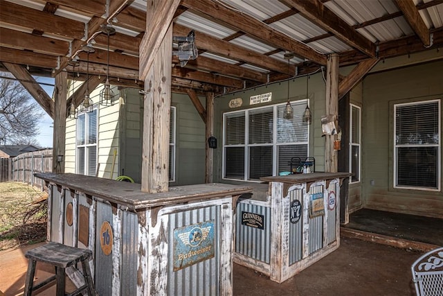 view of patio with fence and outdoor dry bar