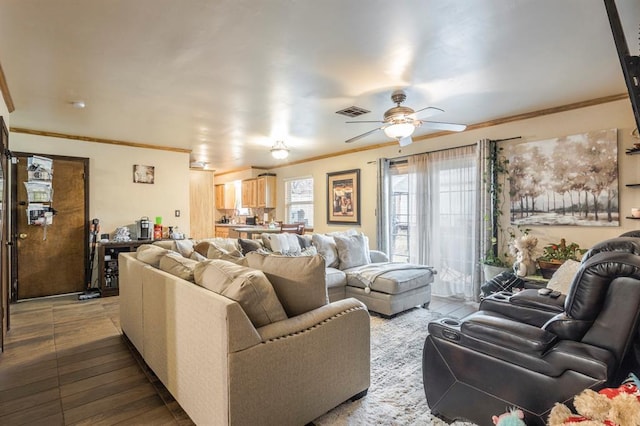 living room featuring ornamental molding and ceiling fan