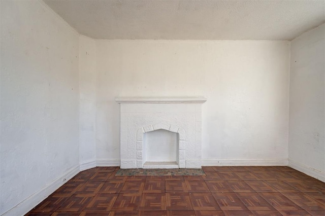 1801 E Madison St, Oklahoma City, OK 73111 - unfurnished living room with a textured ceiling and dark parquet floors