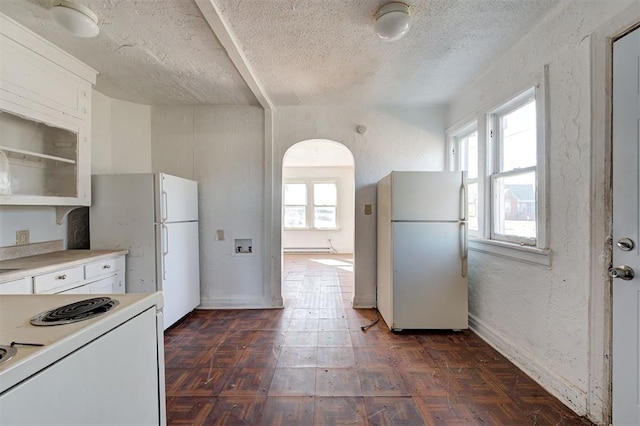 1801 E Madison St, Oklahoma City, OK 73111 - kitchen with a textured ceiling, white appliances, white cabinets, and dark parquet flooring