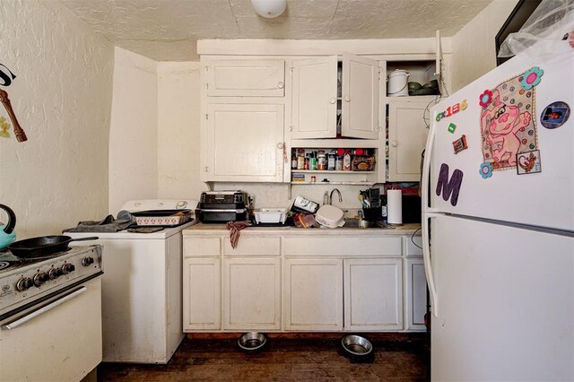 1801 E Madison St, Oklahoma City, OK 73111 - kitchen featuring white appliances, sink, a textured ceiling, dark hardwood / wood-style floors, and washer / clothes dryer