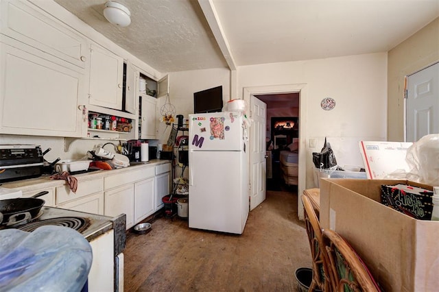 1801 E Madison St, Oklahoma City, OK 73111 - kitchen with hardwood / wood-style flooring, white fridge, white cabinetry, and range with electric cooktop