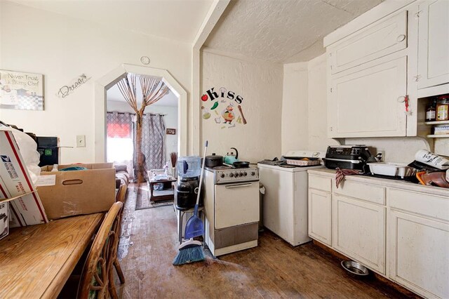 1801 E Madison St, Oklahoma City, OK 73111 - kitchen with a textured ceiling, washer / dryer, white range with electric cooktop, dark hardwood / wood-style flooring, and white cabinets