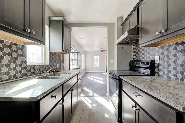 1801 E Madison St, Oklahoma City, OK 73111 - kitchen with sink, black electric range, light stone countertops, and plenty of natural light