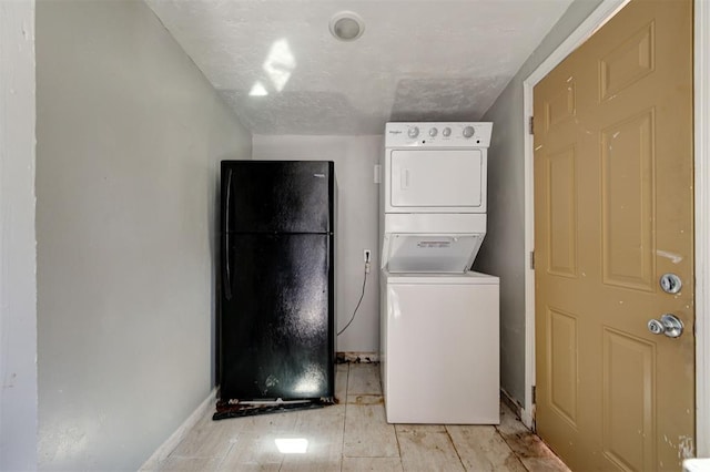 1801 E Madison St, Oklahoma City, OK 73111 - laundry area with light hardwood / wood-style flooring and stacked washer / drying machine