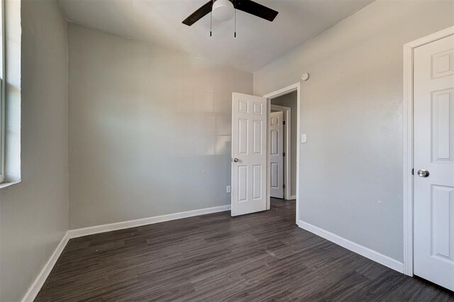 1801 E Madison St, Oklahoma City, OK 73111 - unfurnished bedroom featuring ceiling fan and dark wood-type flooring
