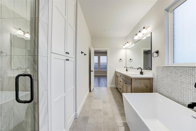 bathroom with vanity and separate shower and tub