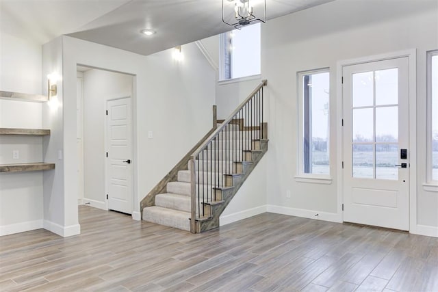 entryway featuring a chandelier and light hardwood / wood-style floors