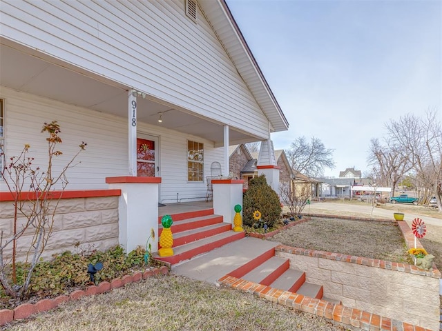 entrance to property featuring a porch and a garage