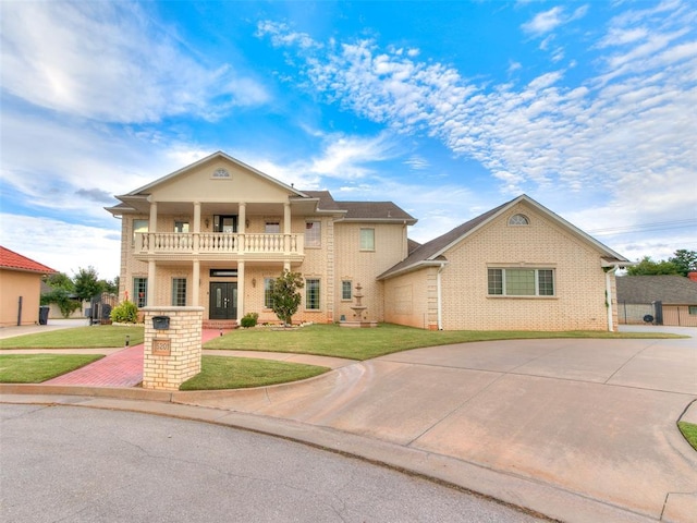 view of front of house featuring a balcony and a front lawn