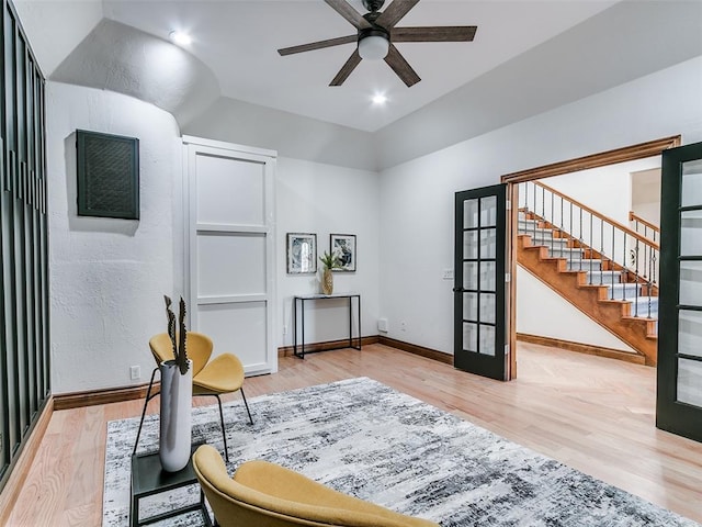 sitting room with light hardwood / wood-style floors, french doors, and ceiling fan