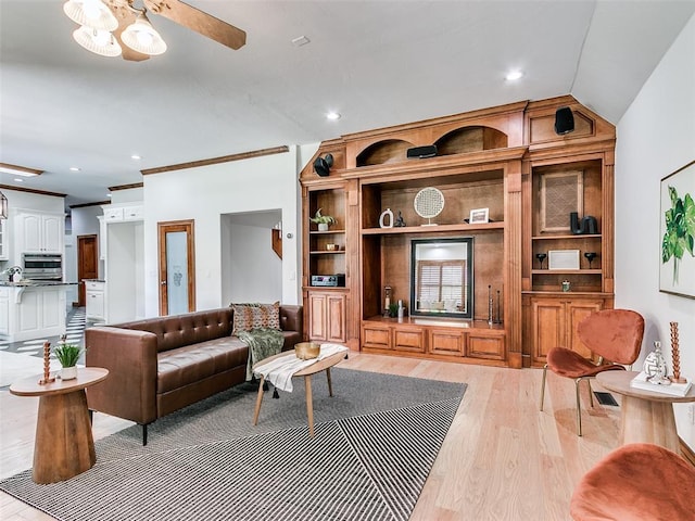 living room with vaulted ceiling, ceiling fan, and light hardwood / wood-style floors