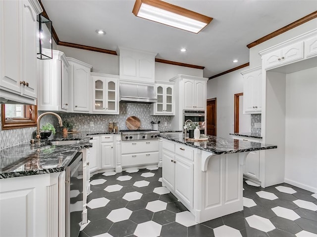 kitchen featuring white cabinetry, sink, and a center island