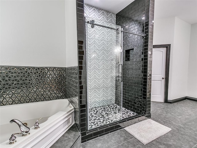 bathroom featuring tile patterned flooring and independent shower and bath