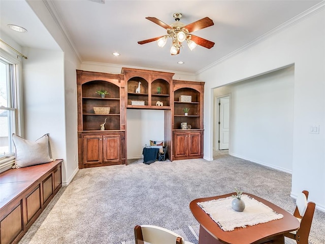 living room with ornamental molding, carpet floors, and ceiling fan