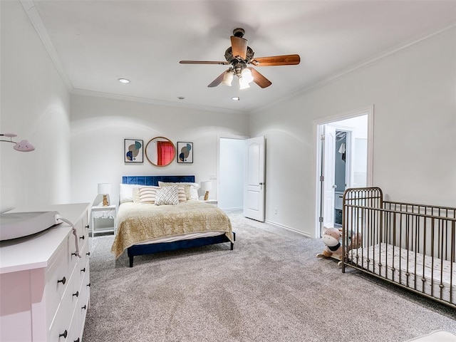 carpeted bedroom featuring crown molding and ceiling fan