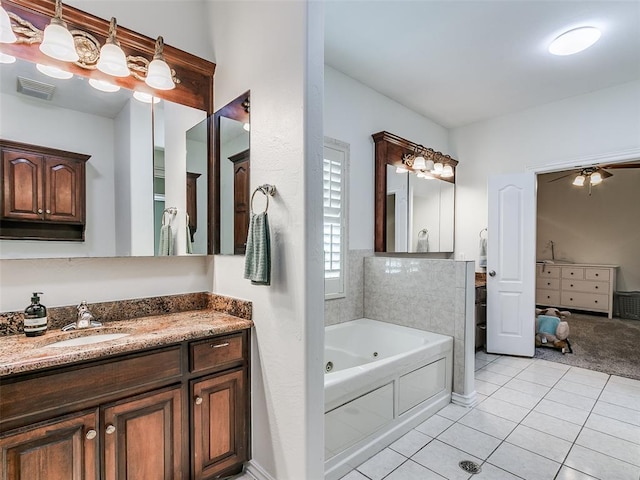 bathroom featuring ceiling fan, tile patterned floors, vanity, and a washtub