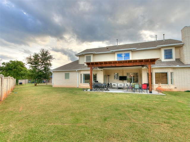 back of property with a patio area and a lawn