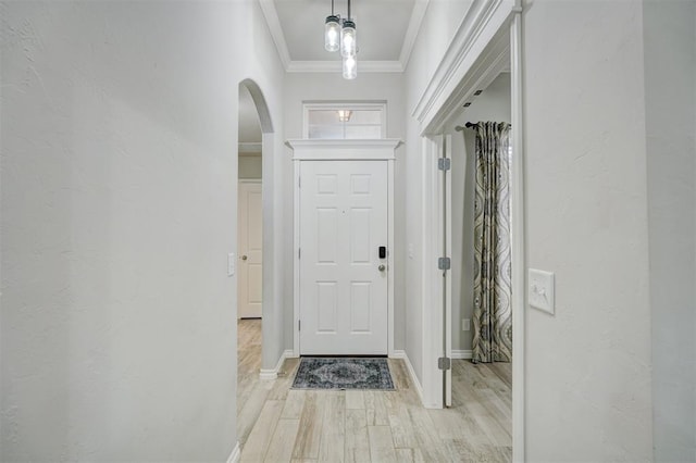 entryway featuring crown molding and light wood-type flooring