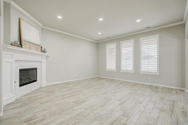 unfurnished living room with light hardwood / wood-style flooring, a fireplace, and ornamental molding