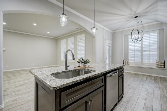 kitchen featuring sink, light stone counters, a center island with sink, light wood-type flooring, and stainless steel dishwasher