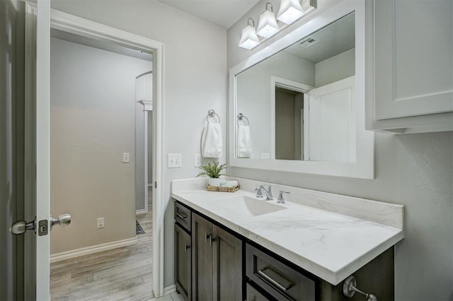 bathroom featuring hardwood / wood-style flooring and vanity