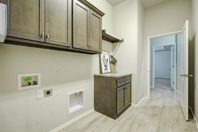 washroom with cabinets, hookup for a washing machine, light hardwood / wood-style flooring, and hookup for an electric dryer