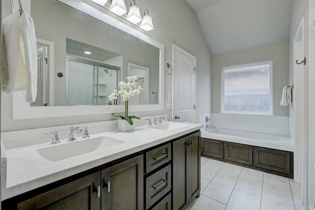 bathroom featuring vanity, lofted ceiling, and separate shower and tub