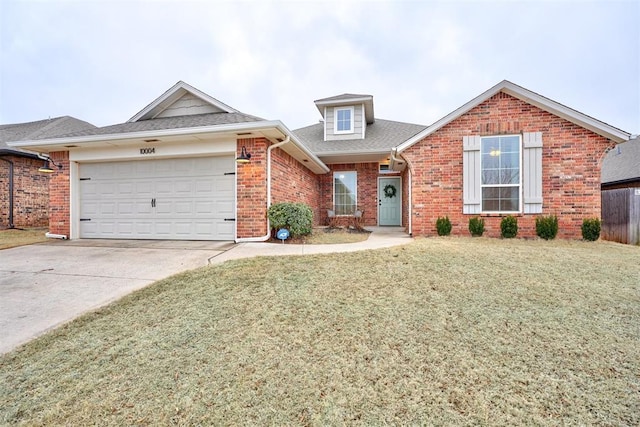 view of front of property featuring a garage and a front lawn