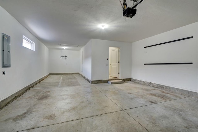 garage with a garage door opener and electric panel