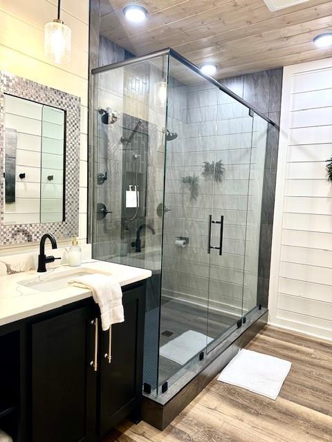 bathroom with vanity, hardwood / wood-style floors, wood ceiling, and an enclosed shower