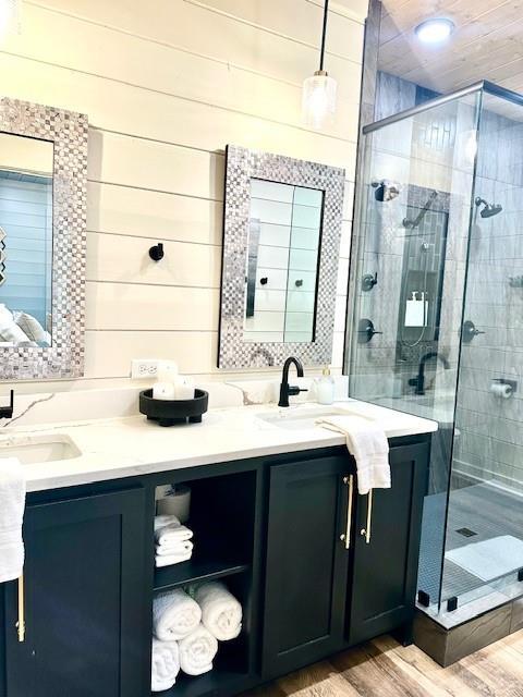 bathroom featuring vanity, wood-type flooring, and walk in shower