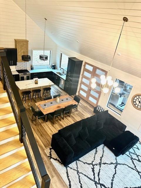 kitchen featuring lofted ceiling, a breakfast bar, and sink