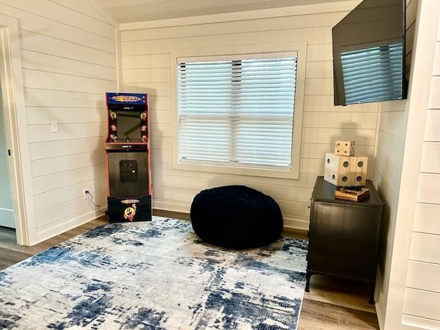 sitting room with lofted ceiling and hardwood / wood-style flooring