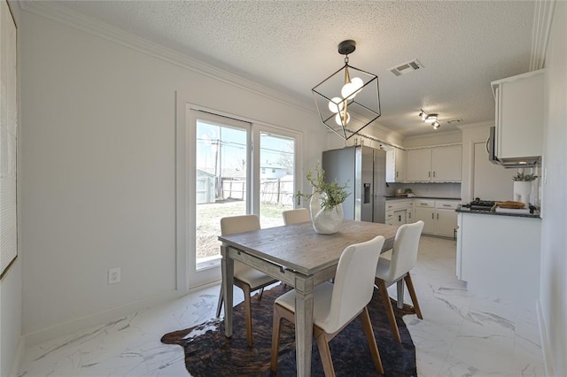 dining room featuring crown molding, a chandelier, and a textured ceiling