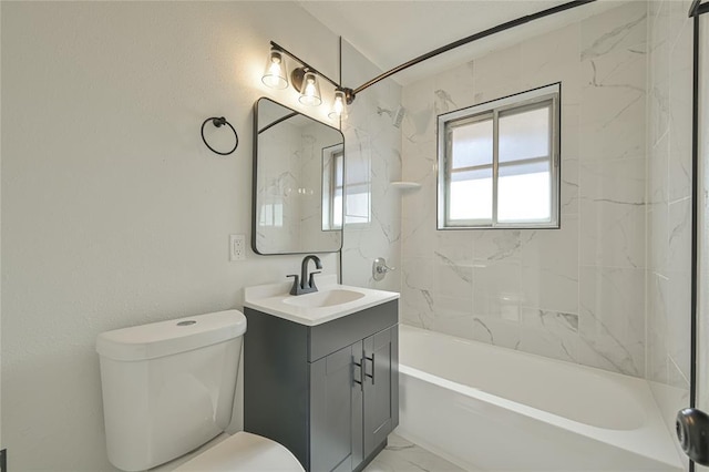 full bathroom featuring tiled shower / bath, vanity, and toilet