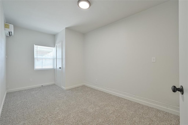 unfurnished room featuring carpet flooring and a wall mounted air conditioner