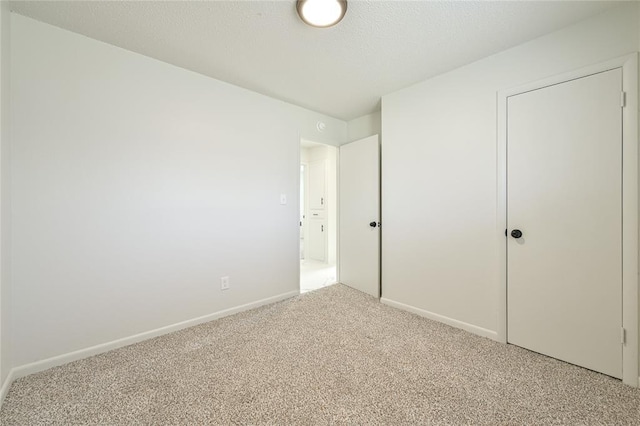 unfurnished bedroom with carpet floors and a textured ceiling