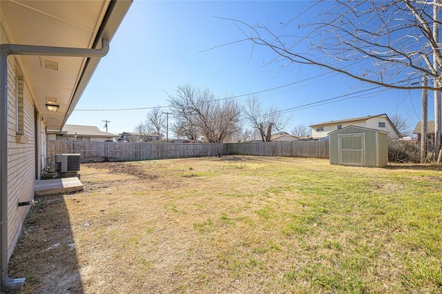 view of yard featuring a storage unit and central air condition unit